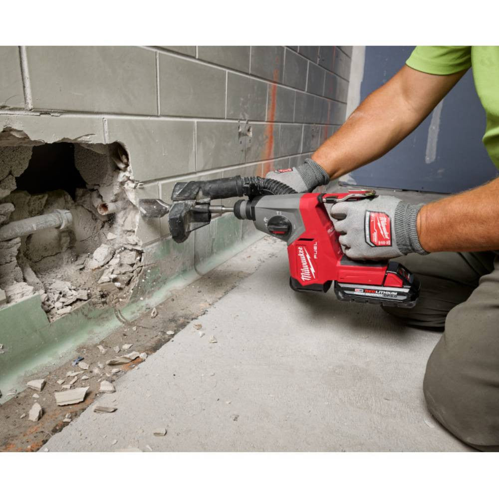 Milwaukee 2908-20 M18 FUEL Cordless Brushless 5/8 inch SDS Plus Rotary Hammer (Tool Only) showing in use chiseling out tiles making a hole in a wall (Battery sold separately)