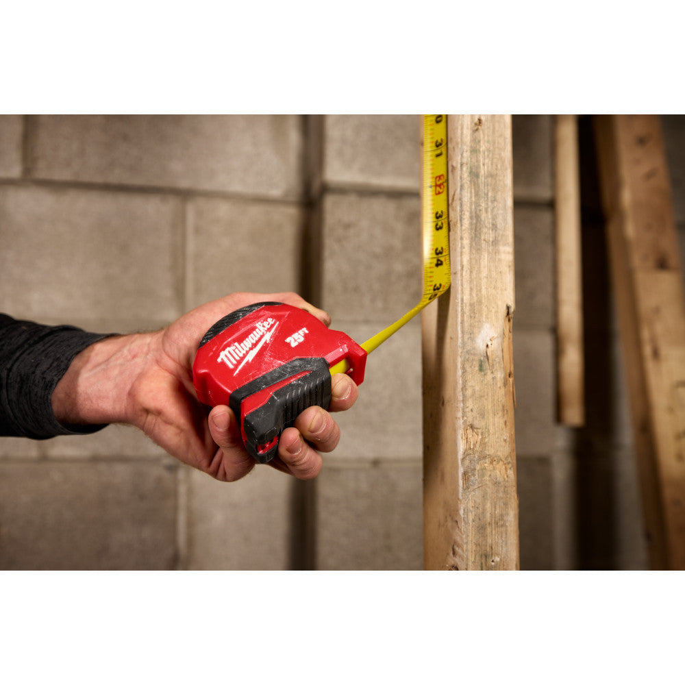 Milwaukee 48-22-1730 30ft Compact Tape Measure showing in use measuring and marking a stud