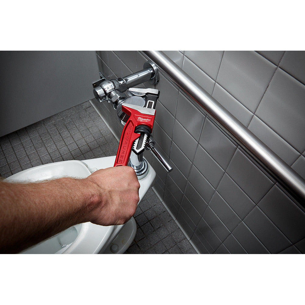 Milwaukee 48-22-7186 12 inch Smooth Jaw Adjustable Wrench showing in use fastening pipe to toilet