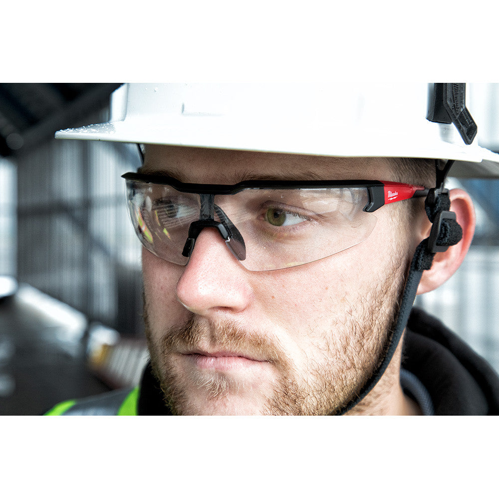 Milwaukee 48-73-2012 Fog-Free Clear Safety Glasses showing in use with contractor wearing them injunction with a hard hat