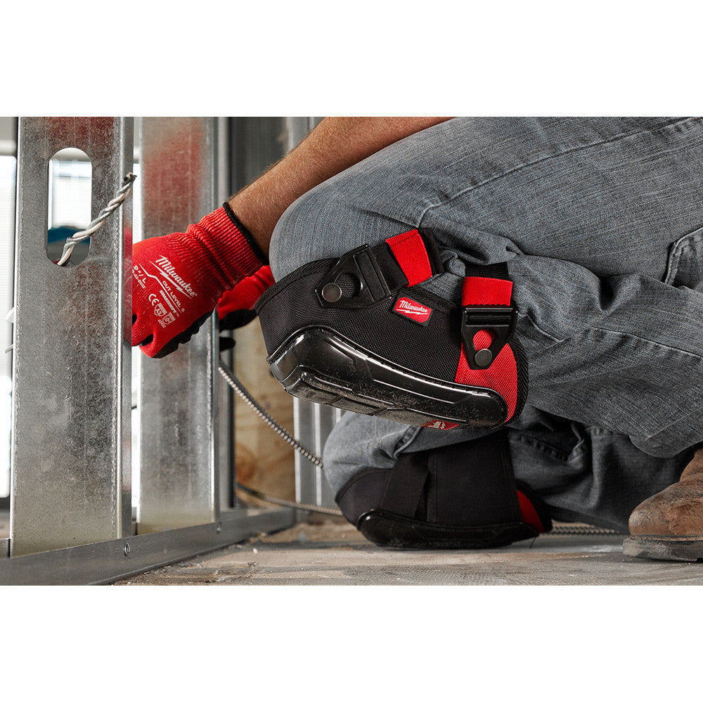 Milwaukee 48-73-6030 Performance Hard Shell Knee Pads showing in use being worn by you while installing steel studs