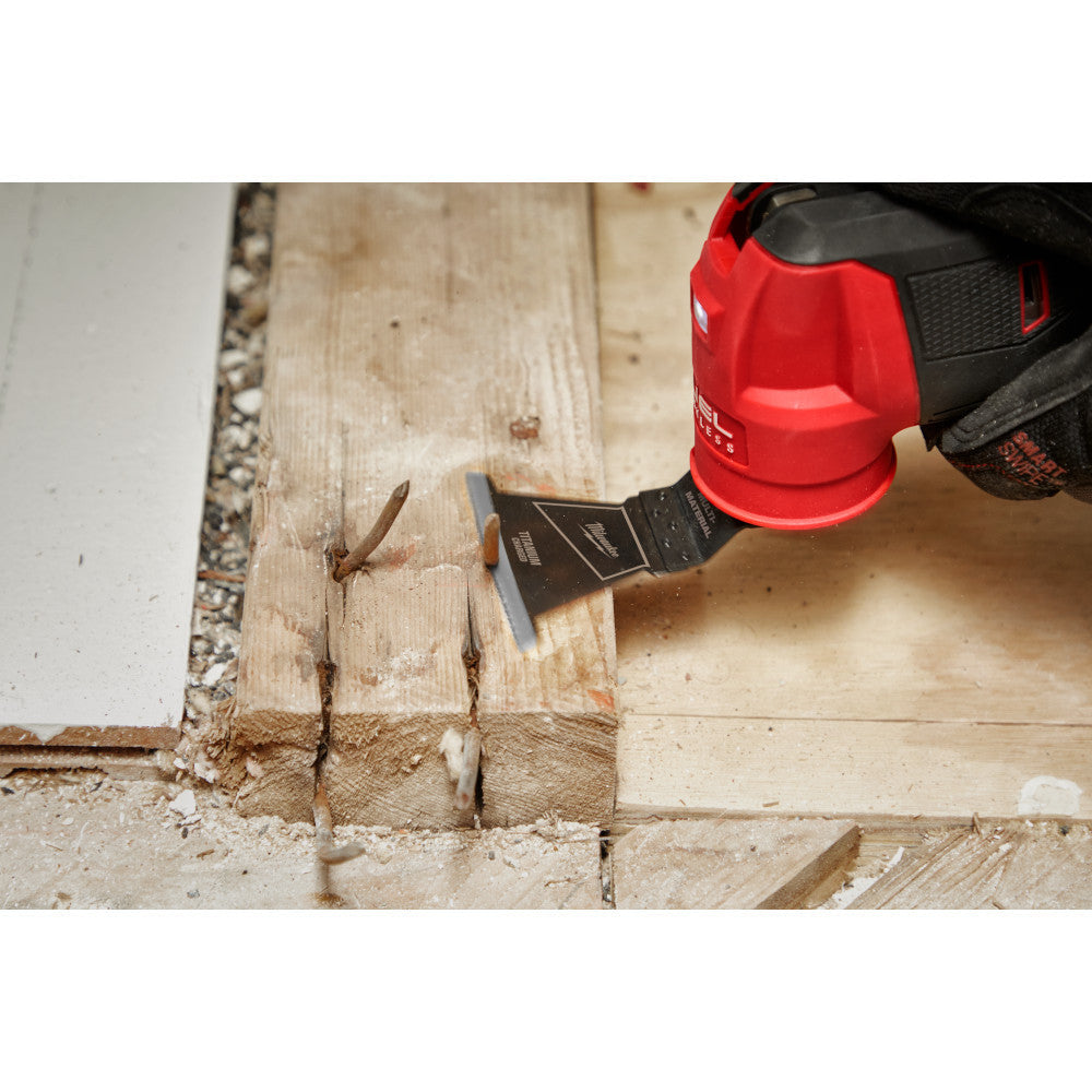 Milwaukee 49-25-1241 OPEN-LOK 2-1/2-inch Universal Fit Titanium Enhanced Bi-Metal Multi-Material Cutting Multi-Tool Oscillating Blade showing in use cutting nail sticking out of a 2 inchX4 inch wood stud