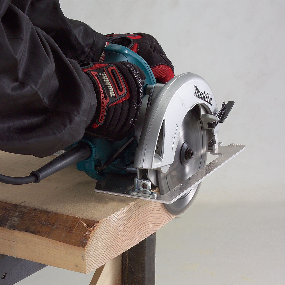 Makita 5007NB 15 Amp 7-1/4 inch Circular Saw showing in use cutting through dimensional lumber