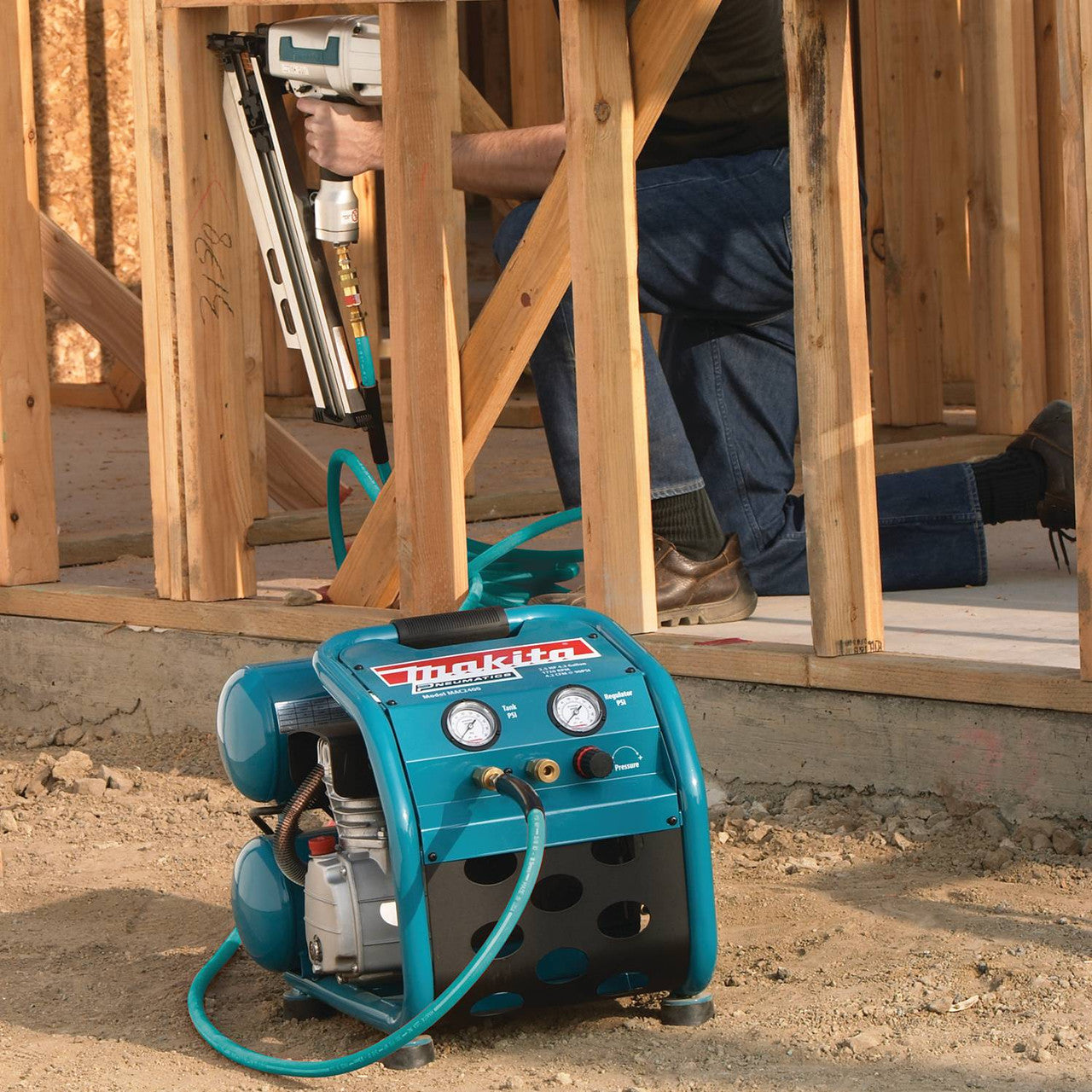 Makita MAC2400 12.3 Amp 2.5 HP Big Bore 4 Gallon Air Compressor showing compressor resting on a jobsite
