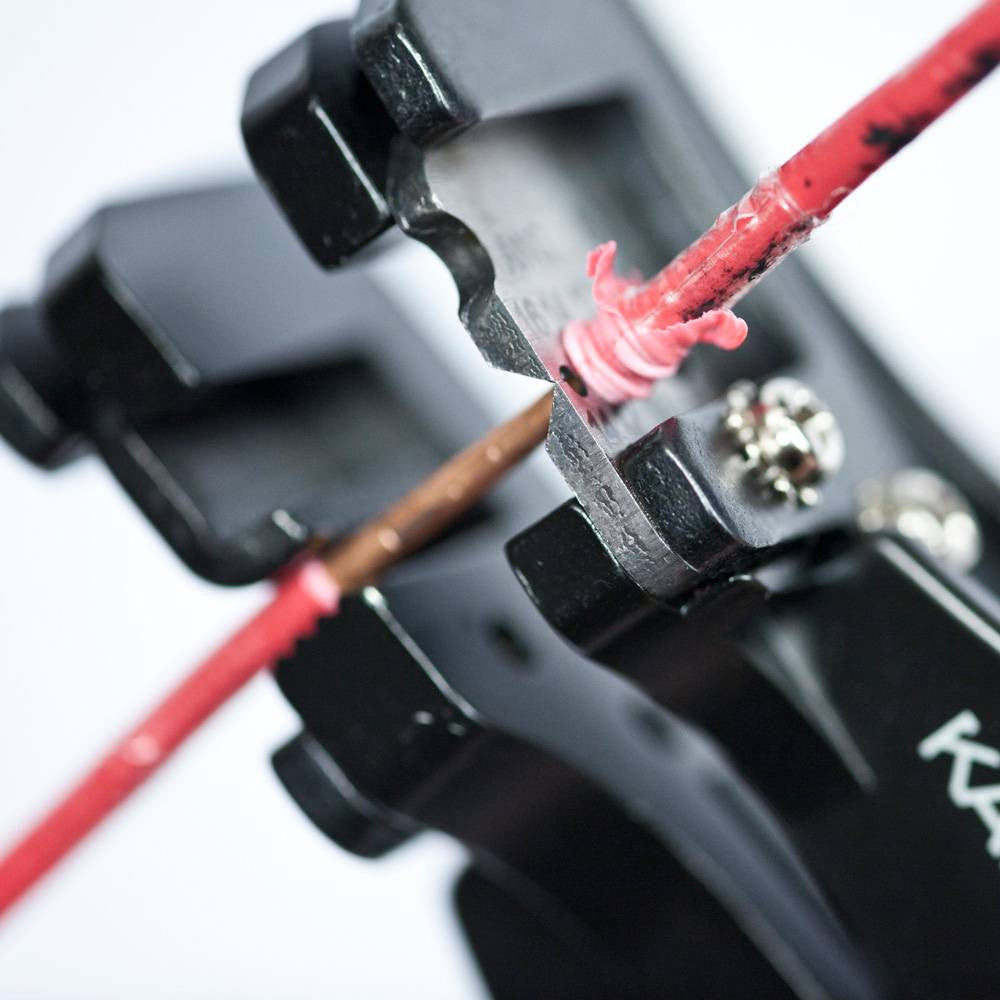 Klein Tools 11063W 8-22 AWG Solid & Stranded Katapult Wire Stripper & Cutter showing in use stripping electrical cable