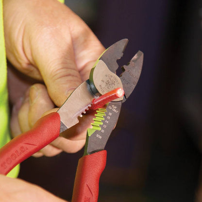 Klein Tools 2005N Forged Steel Wire Crimper, Cutter, Stripper showing in use stripping electrical cable