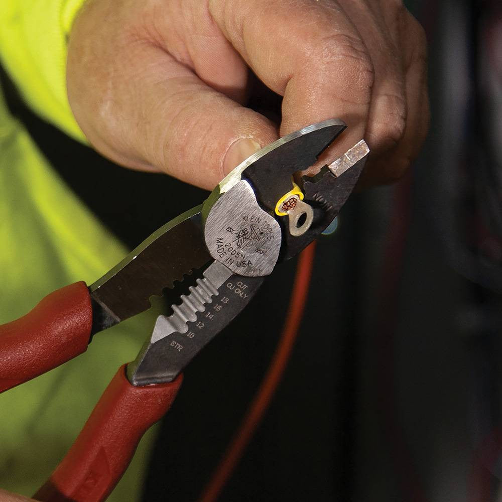Klein Tools 2005N Forged Steel Wire Crimper, Cutter, Stripper showing in use crimping electrical terminal connector