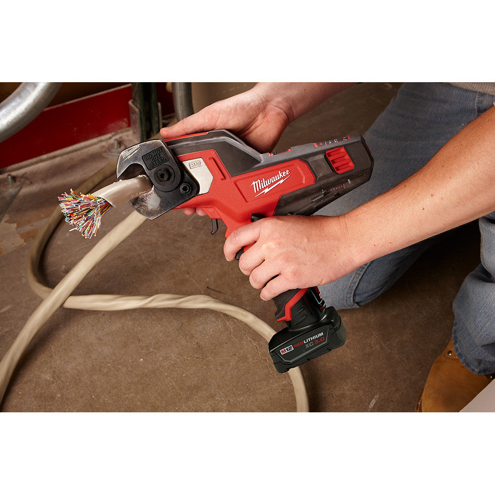 Milwaukee 2472-21XC M12 Cordless 600 MCM Cable Cutter Kit showing in use cutting off damaged in end of a cable