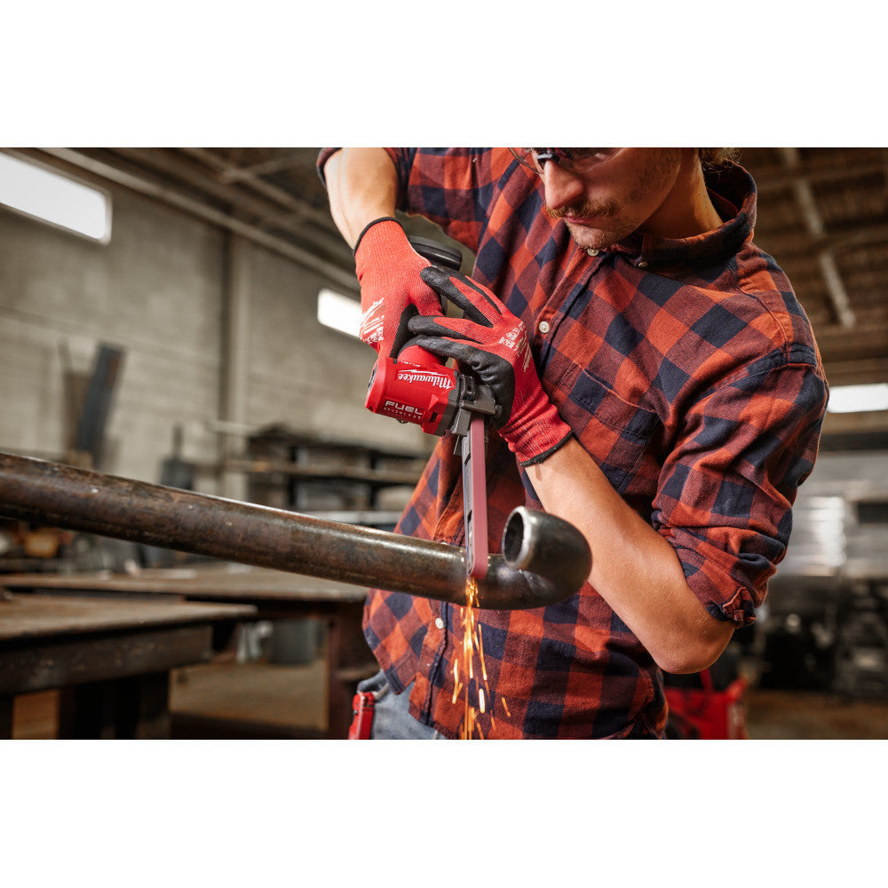 Milwaukee 2482-20 M12 FUEL Cordless Brushless 1/2 inch x 18 inch Bandfile (Tool Only) showing in use filing joint on metal pipe
