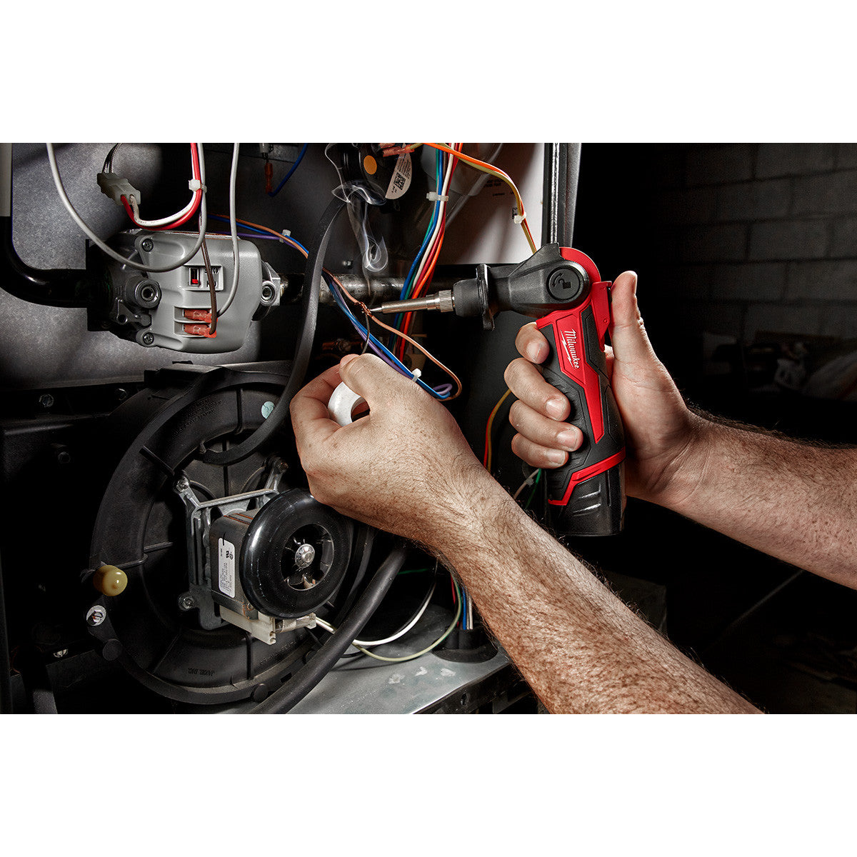 Milwaukee 2488-20 M12 Cordless Soldering Iron working in a tight space with head pivoted 90 degrees (battery sold separately)