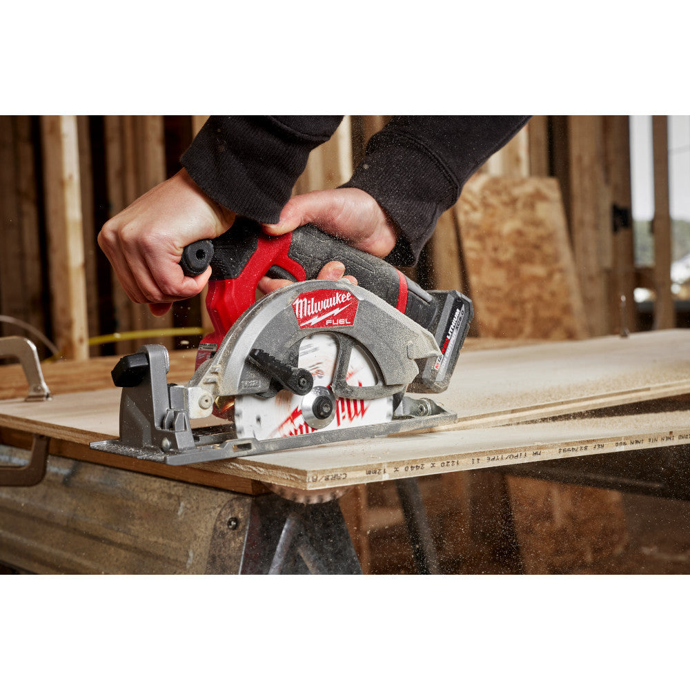 Milwaukee 2521-20 12V FUEL 5-3/8in Circular Saw (Tool Only) showing in use cutting through plywood (Battery Sold Separately)
