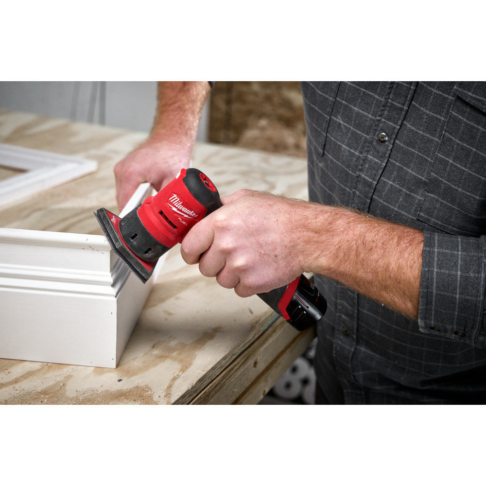 Milwaukee 2531-20 M12 FUEL Cordless Brushless Orbital Detail Sander (Tool Only) showing in use sanding molding with various contours