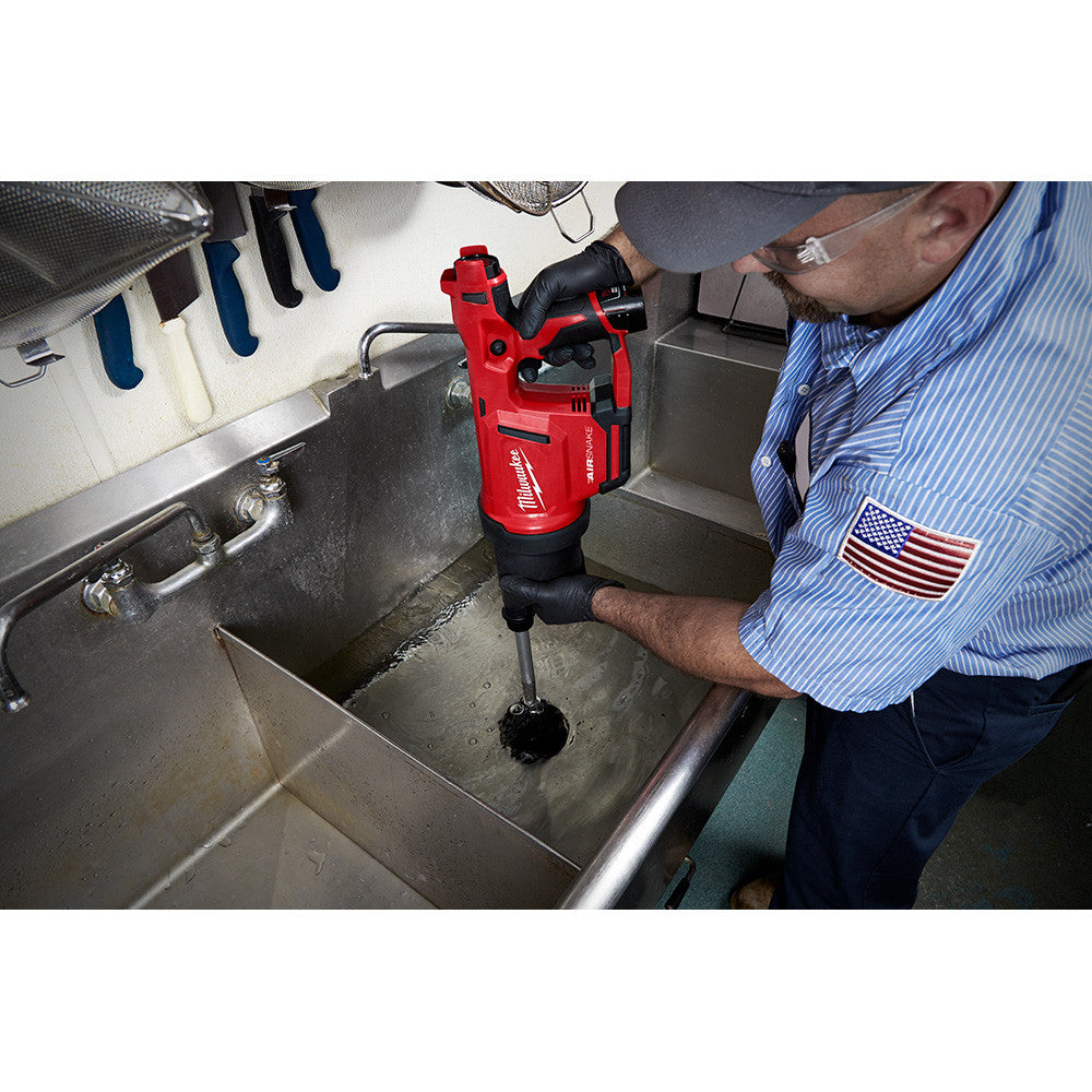 Milwaukee 2572B-21 M12 AIRSNAKE Cordless Drain Cleaning Air Gun Kit showing in use clearing a sink clog
