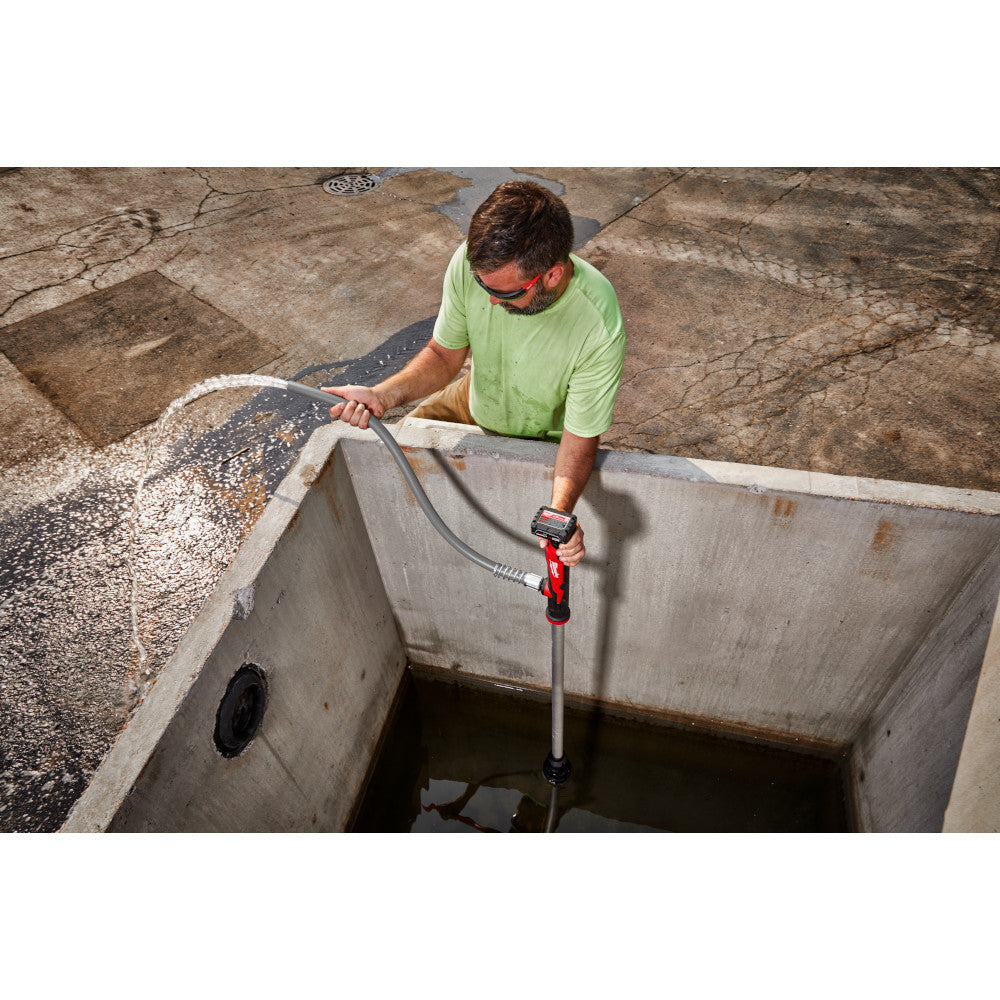Milwaukee 2579-20 M12 Cordless Stick Transfer Pump (Tool Only) showing in use removing water from concrete water cache
