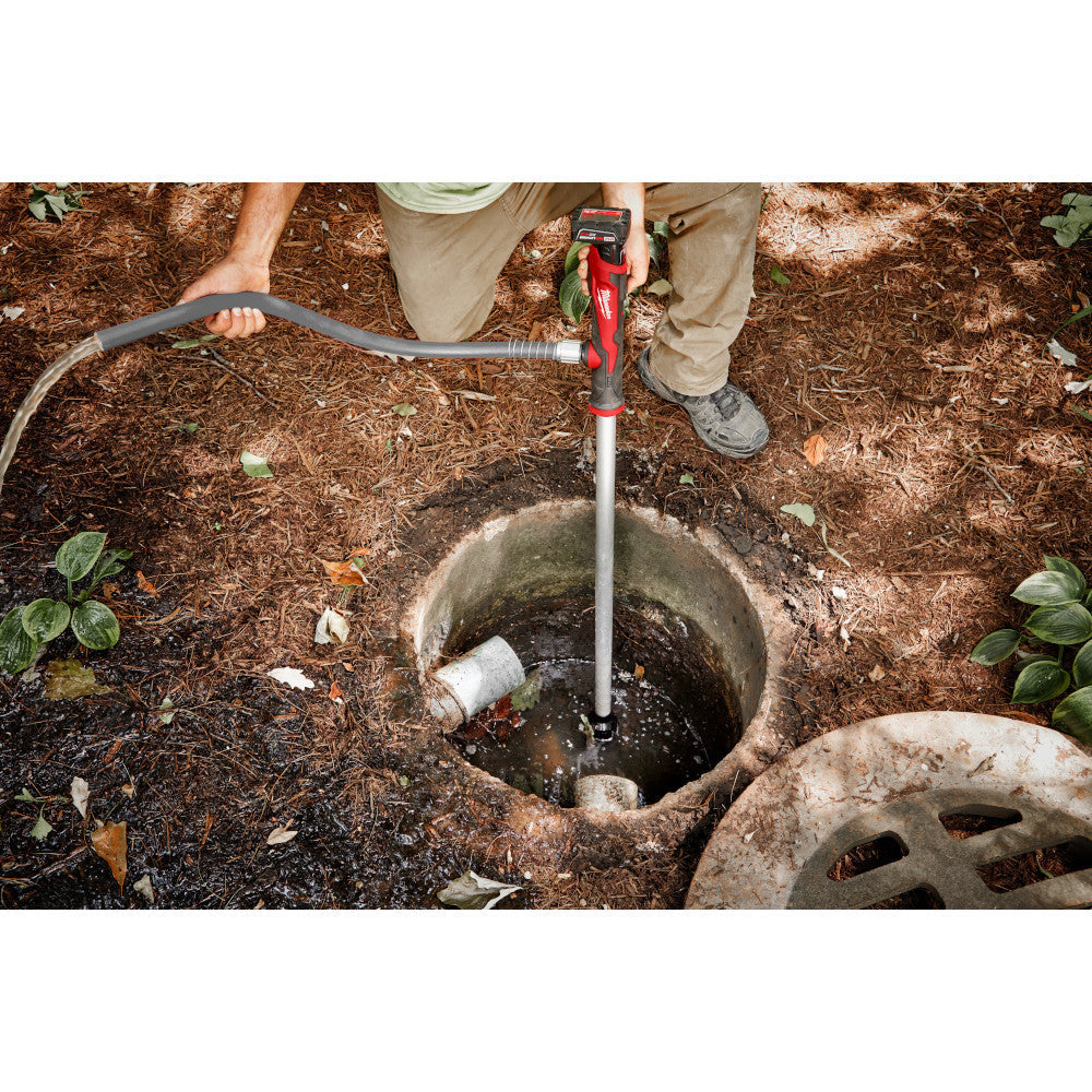 Milwaukee 2579-20 M12 Cordless Stick Transfer Pump (Tool Only) showing in use removing water from drain system