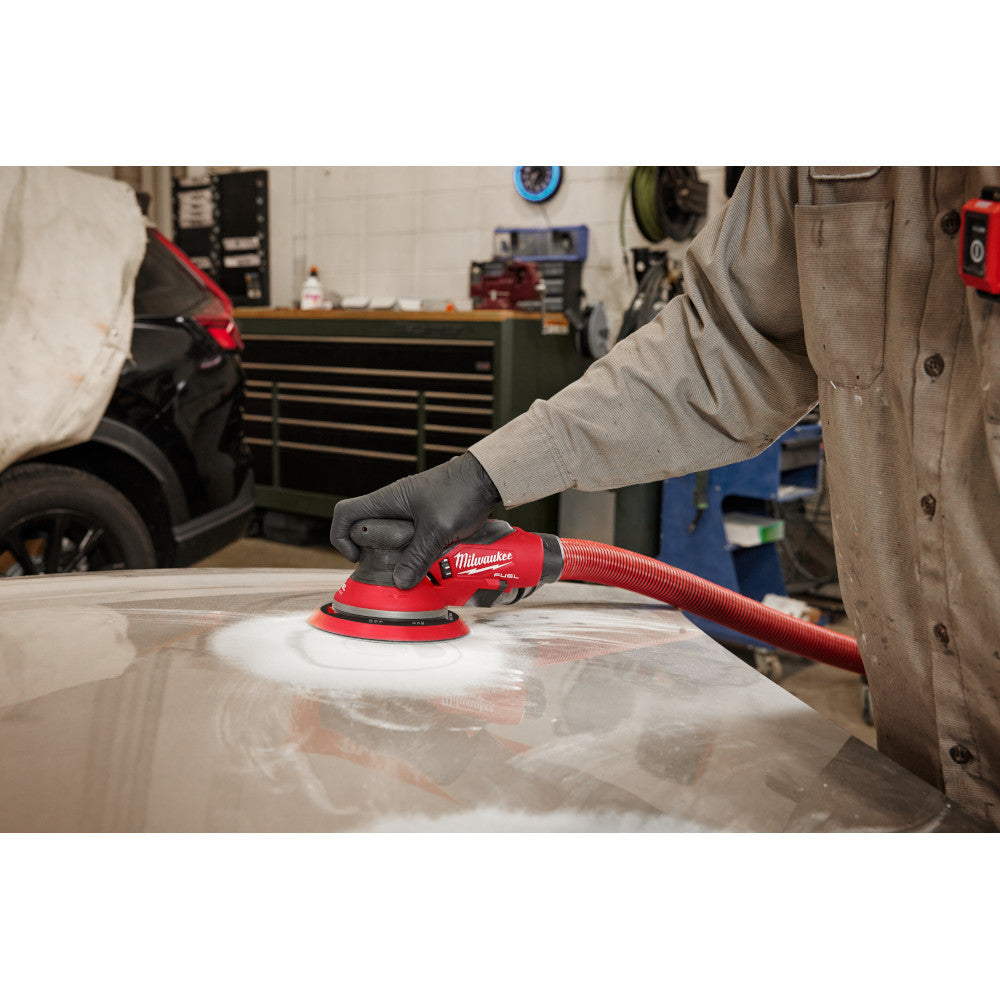 Milwaukee 2585-20 12V FUEL 6in Random Orbital Sander (Tool Only) showing in use sanding down body filler on car part (Battery Sold Separately)