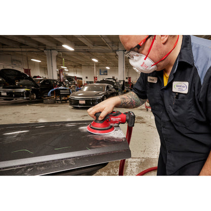 Milwaukee 2585-20 12V FUEL 6in Random Orbital Sander (Tool Only) showing in use sanding down body filler on car part (Battery Sold Separately)