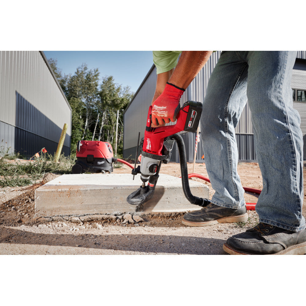 Milwaukee 2613-20 M18 Cordless Brushless 1 inch SDS Plus D-Handle Rotary Hammer (Tool Only) showing in use drilling downward through a concrete slab