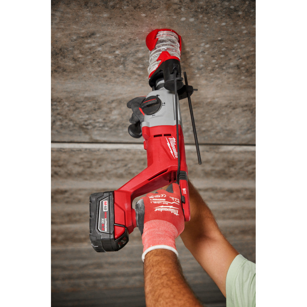 Milwaukee 2613-20 M18 Cordless Brushless 1 inch SDS Plus D-Handle Rotary Hammer (Tool Only) showing in use drilling upward with a core bit into a concrete ceiling