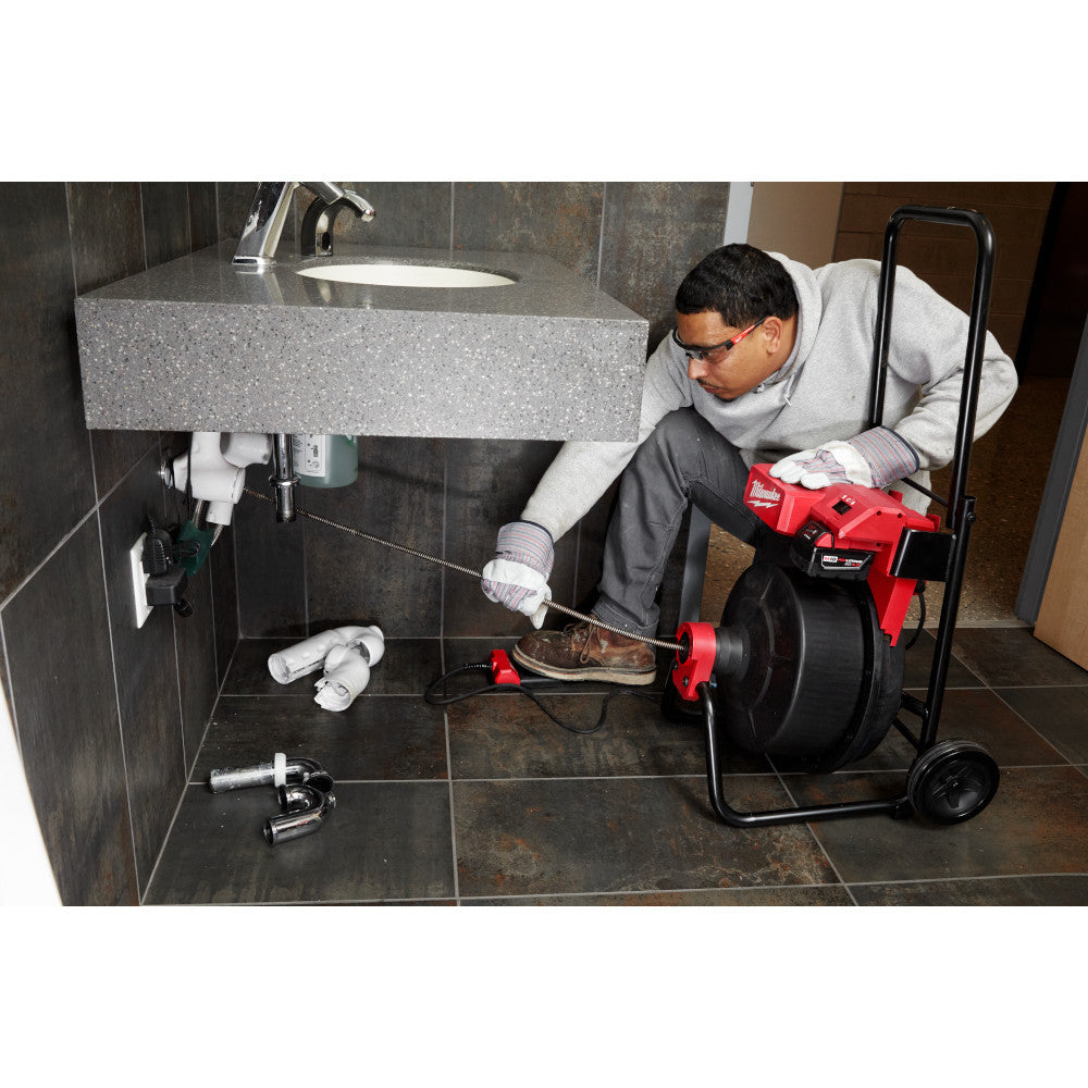 Milwaukee 2817A-21 18V DRUM MACHINE with 3/8in CABLE showing in use cleaning out drainage pipe of a sink