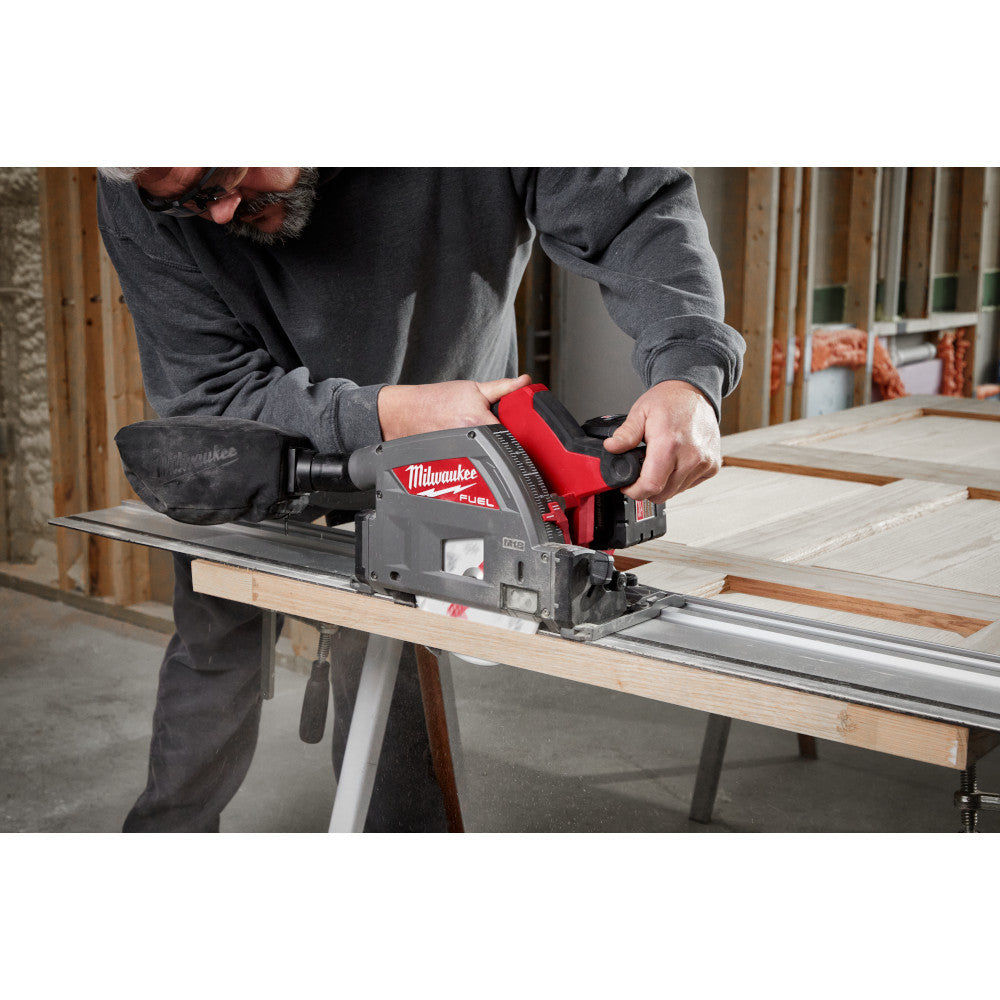 Milwaukee 2831-20 M18 FUEL Cordless Brushless 6-1/2 inch Plunge Track Saw (Tool Only) showing in use cutting down a door