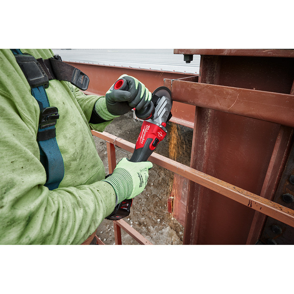 Milwaukee 2887-20 M18 FUEL Cordless Brushless 5 inch Flathead Braking Grinder with Slide Switch No-Lock (Tool Only) showing in use cutting metal flat stock outside