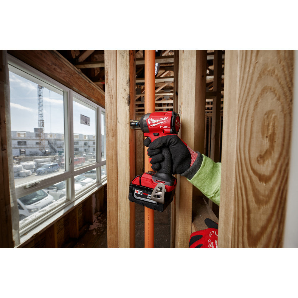 Milwaukee 2953-20 M18 FUEL 1/4 inch Hex Impact Driver (Tool Only) showing in use driving screw into wooden stud attaching two stud together