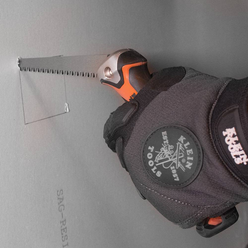 Klein Tools 31737 Folding Jab Saw showing in use cutting through drywall to find a junction box