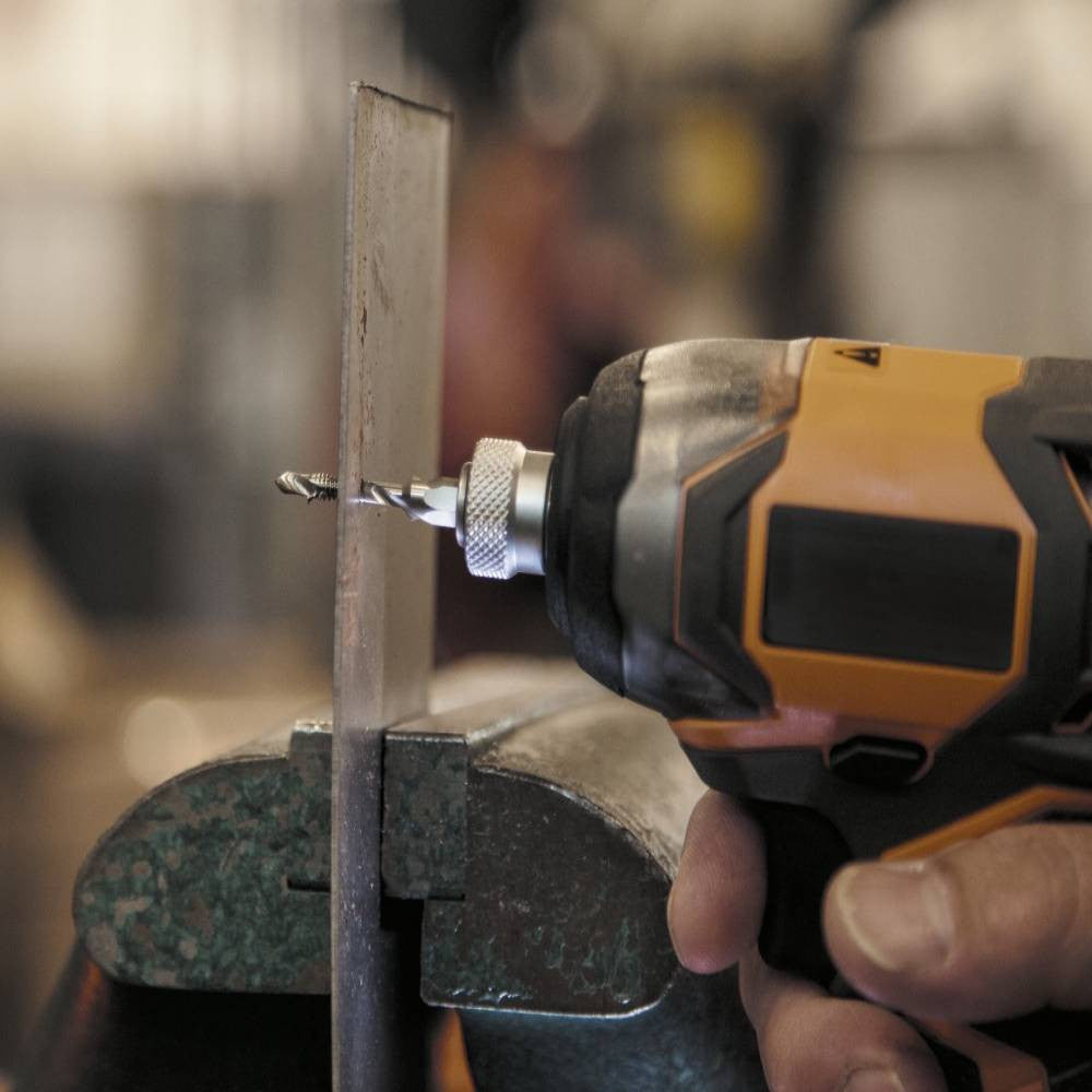 Klein Tools 32217 8pc Drill Tap Tool Kit showing in use drilling and taping a hole in steel while steel is held in vise