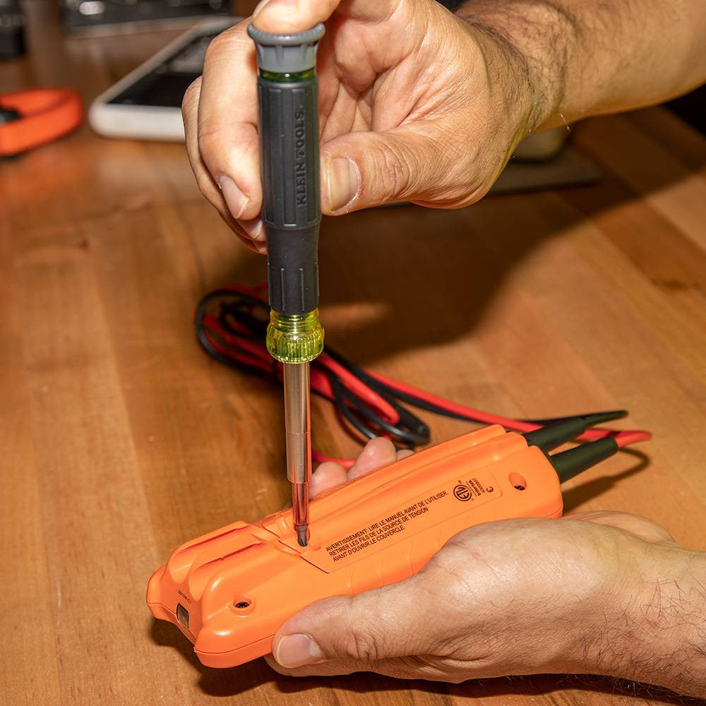 Klein Tools 32314 14-In-1 Multi-Bit Precision Screwdriver / Nut Driver  showing in use fastening a screw into a meter