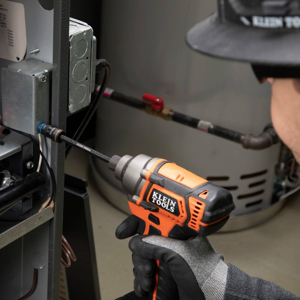 Klein Tools 32910 7-in-1 Impact Rated Flip Socket Set with Handle showing in use fastening screw in to electrical panel attached to impact driver