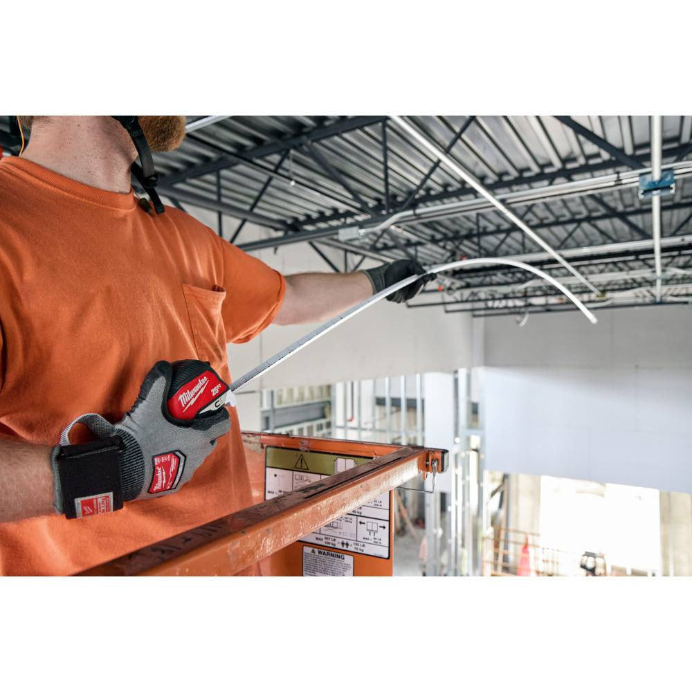 Milwaukee 48-22-1027M 25' Electrician's Magnetic Tape Measure showing in use measuring the distance of an area using the standout