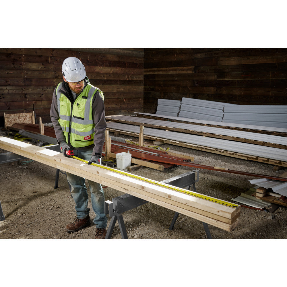 Milwaukee 48-22-1216 16ft Wide Blade Tape Measure showing in action measuring and marking studs