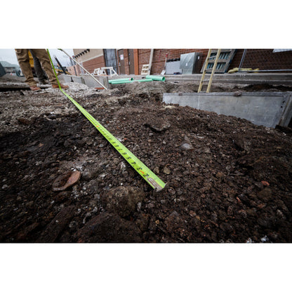 Milwaukee 48-22-1425 25ft Stud Tape Measure showing in use measuring an area of dirt for work