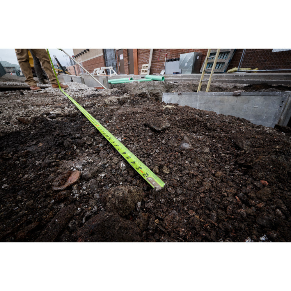 Milwaukee 48-22-1426 26ft/8m Stud Tape Measure showing in use measuring an area of dirt for work