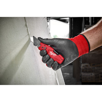 Milwaukee 48-22-1505 FASTBACK 6-In-1 Folding Utility Knife showing in use cutting sheet of drywall
