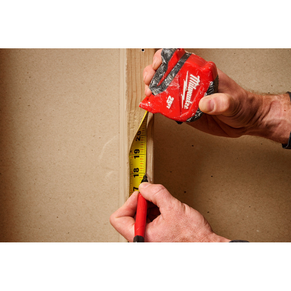 Milwaukee 48-22-1725 25ft Compact Tape Measure showing in use measuring and marking a stud