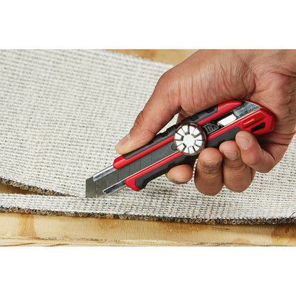 48-22-1961 18mm Snap Off Knife with Metal Lock and Precision Cut Blade showing in use cutting carpet through the back