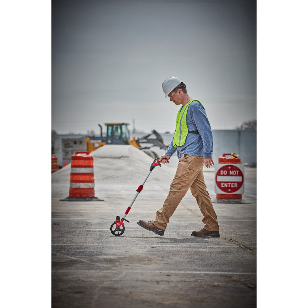 Milwaukee 48-22-5006 6 inch Measuring Wheel showing in use measuring out on concrete pad