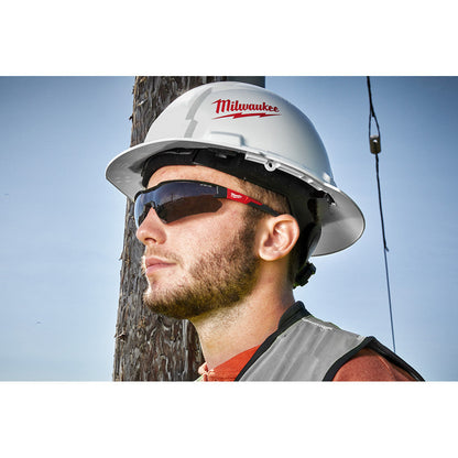 Milwaukee 48-73-2015 Anti-Scratch Tinted Safety Glasses showing in use with contractor wearing them injunction with a hard hat