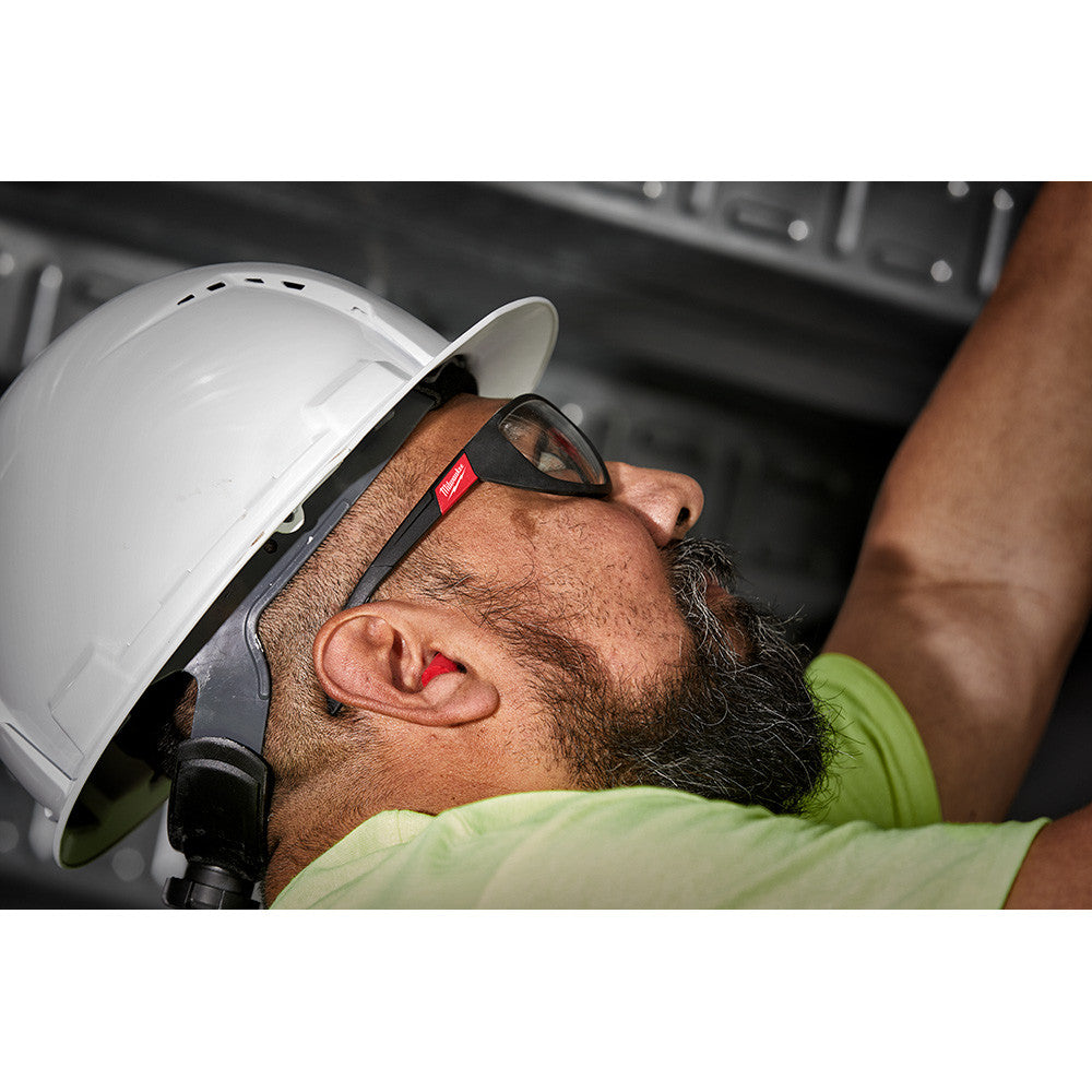 Milwaukee 48-73-3005 Foam Ear Plugs - 100 Pairs showing in use in workers ears while working over head