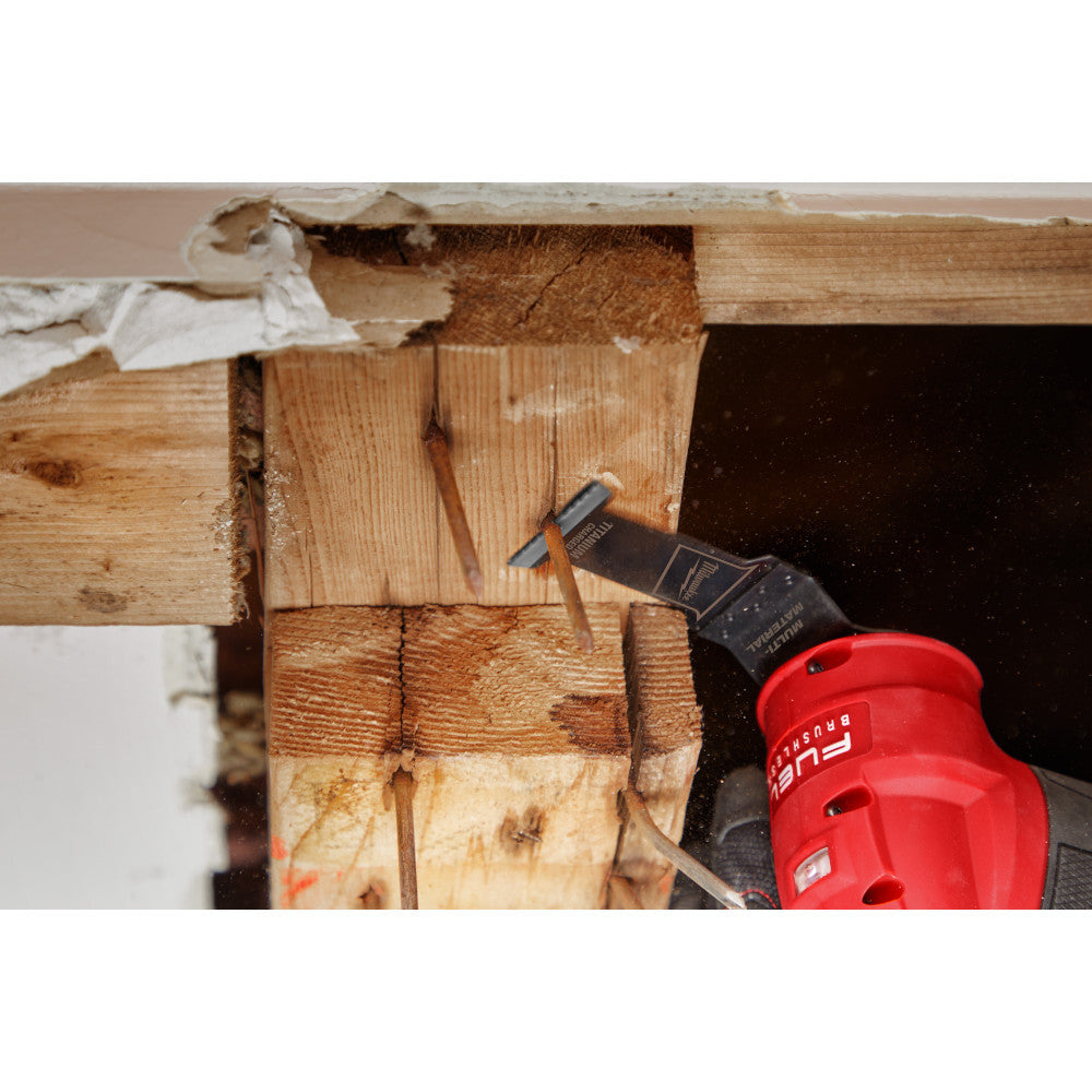 Milwaukee 49-10-9001 OPEN-LOK 3pc Universal Fit All-Purpose Multi-Tool Oscillating Blade Set showing in use cutting nail sticking out of a frame beam