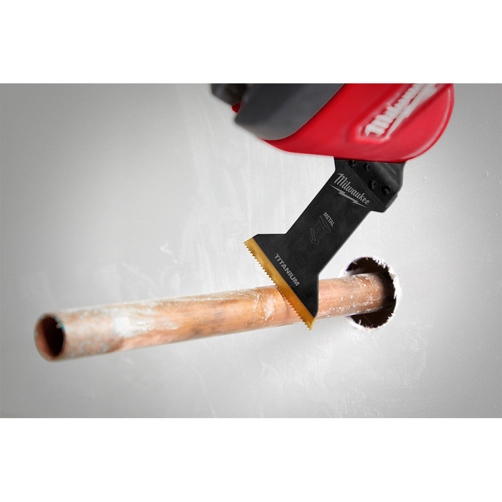 Milwaukee 49-25-1263 OPEN-LOK 1-3/4-inch Universal Fit Titanium Enhanced Bi-Metal Metal Cutting Multi-Tool Oscillating Blades - 3pk showing in use cutting copper pipe while poking through a drywall wall