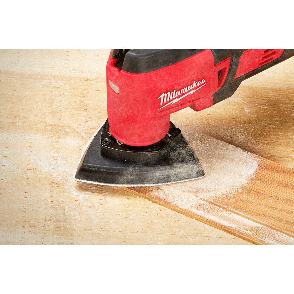 Milwaukee 49-25-2009 OPEN-LOK 10pc 3-1/2-inch Triangle Universal Fit Multi-Tool Oscillating Sanding Pad & Paper Set showing in use sanding finish off of baseboards