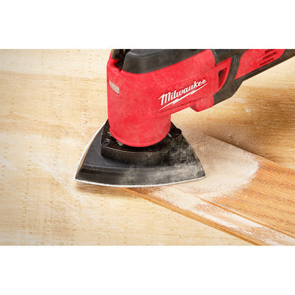 Milwaukee 49-25-2009 OPEN-LOK 10pc 3-1/2-inch Triangle Universal Fit Multi-Tool Oscillating Sanding Pad & Paper Set showing in use sanding finish off of baseboards