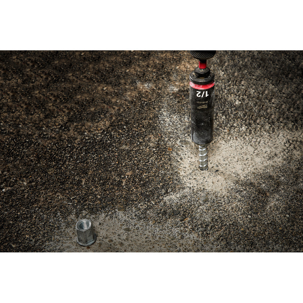 Milwaukee 48-32-5031 SHOCKWAVE Impact Duty 2 inch x 3/8 inch Square Socket Adapter showing attachment in use with socket attached fastening bolt into concrete (Socket sold separately)