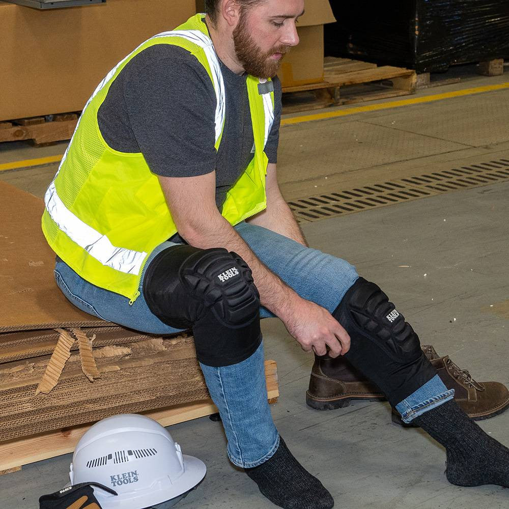 Klein Tools 60592 Lightweight Knee Pad Sleeves - L/XL showing knee pad sleeves being put on