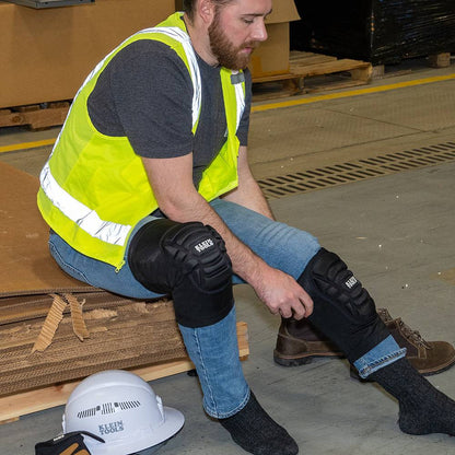 Klein Tools 60592 Lightweight Knee Pad Sleeves - L/XL showing knee pad sleeves being put on