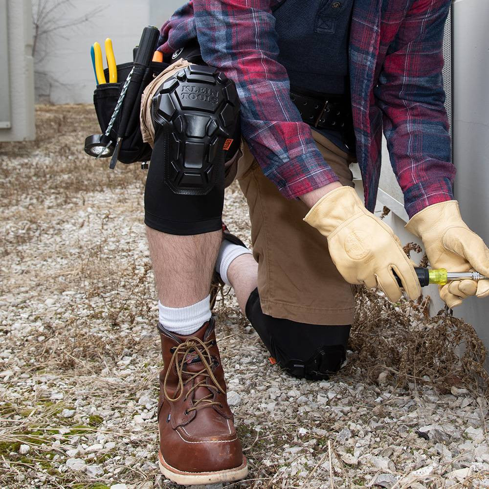 Klein Tools 60511 Heavy Duty Knee Pad Sleeves - M/L showing being worn and kneeling on gravel while working