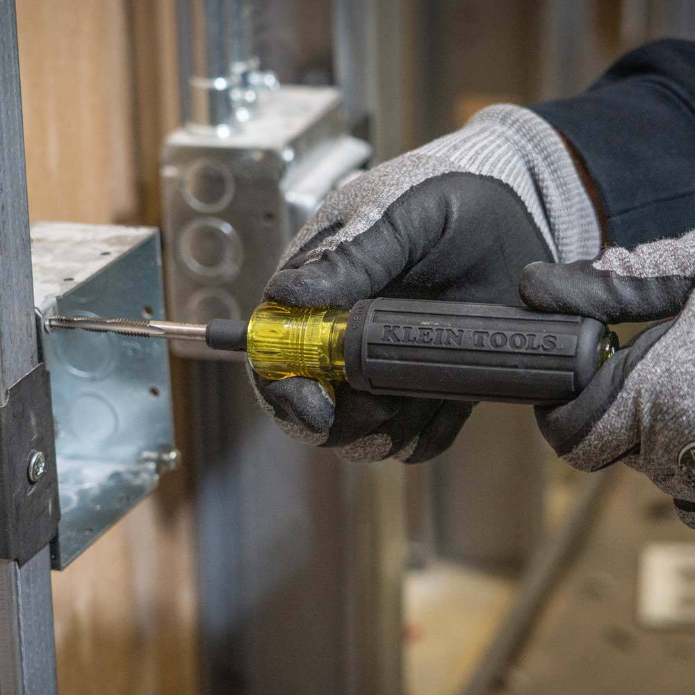 Klein Tools 626 6-in-1 Tapping Tool showing in use tapping a larger hole into a junction box